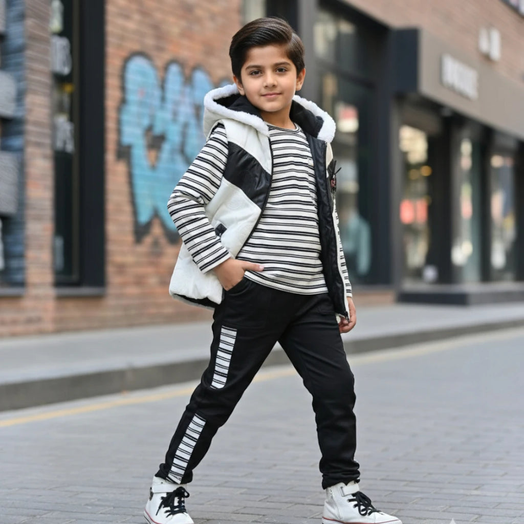 Boy wearing black and white hooded winter jacket, striped shirt, and matching jogger pants.