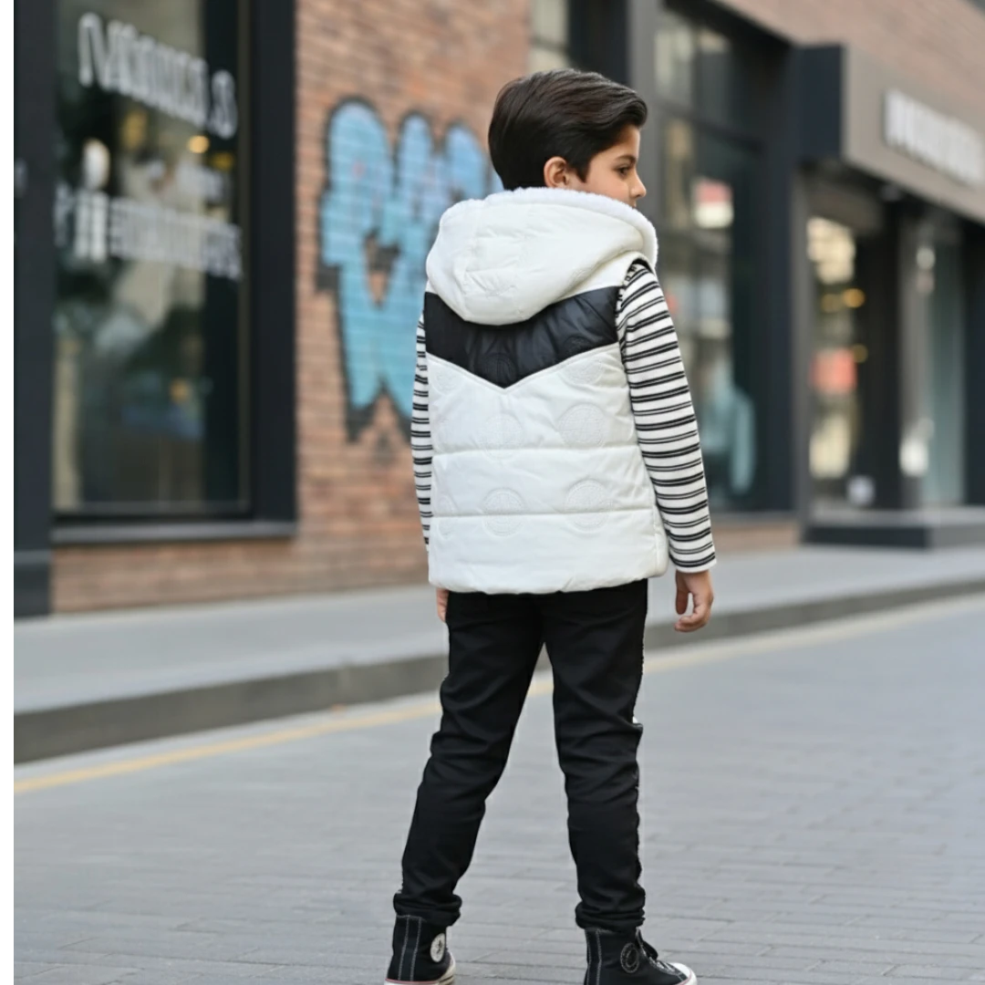 Boy wearing black and white hooded winter jacket, striped shirt, and matching jogger pants.